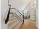 Staircase leading to the home's entryway with vaulted ceiling, large windows, and chandelier at 2258 N Gentry --, Mesa, AZ 85213