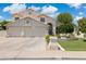 Inviting two-story home featuring a three-car garage and manicured front yard at 2258 N Gentry --, Mesa, AZ 85213