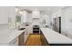 Well-lit kitchen with white cabinets, stone countertops and stainless steel appliances at 2258 N Gentry --, Mesa, AZ 85213