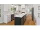 Modern kitchen with white cabinets, an island, and stainless steel appliances at 2258 N Gentry --, Mesa, AZ 85213