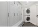 Well-organized laundry room featuring stackable washer and dryer, and ample storage cabinets at 2258 N Gentry --, Mesa, AZ 85213