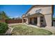 A manicured backyard featuring a covered patio, low-maintenance landscaping, and a partial grass area at 22706 N 17Th St, Phoenix, AZ 85024