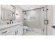 Modern bathroom featuring a sleek vanity, stylish mirror, and a glass-enclosed shower with black fixtures at 22706 N 17Th St, Phoenix, AZ 85024