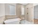 Bright bathroom with a soaking tub and a glass-enclosed shower featuring stylish tile work at 22706 N 17Th St, Phoenix, AZ 85024