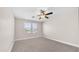 An empty bedroom featuring neutral carpet, natural light from two windows, and a ceiling fan at 22706 N 17Th St, Phoenix, AZ 85024