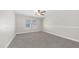An empty bedroom showcasing neutral carpet, natural light from two windows, and a ceiling fan at 22706 N 17Th St, Phoenix, AZ 85024