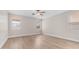 Spacious bedroom featuring light wood floors, neutral walls, and a ceiling fan for added comfort at 22706 N 17Th St, Phoenix, AZ 85024