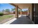 A covered patio featuring low-maintenance backyard landscaping with a partial grass area and desert plants at 22706 N 17Th St, Phoenix, AZ 85024