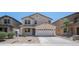 Exterior of a two-story home featuring stucco siding, a two-car garage, and low-maintenance landscaping at 22706 N 17Th St, Phoenix, AZ 85024