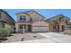 Exterior of a two-story home featuring stucco siding, a two-car garage, and low-maintenance landscaping at 22706 N 17Th St, Phoenix, AZ 85024