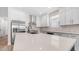 Modern kitchen featuring stainless steel appliances, white countertops, a large island, and plenty of counter space at 22706 N 17Th St, Phoenix, AZ 85024