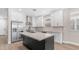 Modern kitchen with stainless steel appliances, a large island, and white cabinetry at 22706 N 17Th St, Phoenix, AZ 85024