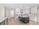 Bright kitchen features white cabinets, stainless steel appliances, light backsplash, and an island with seating at 22706 N 17Th St, Phoenix, AZ 85024
