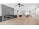 Spacious living room with a fireplace, ceiling fan, and a modern open concept kitchen at 22706 N 17Th St, Phoenix, AZ 85024