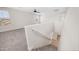 Staircase featuring carpet on stairs and hallway with neutral walls and a handrail for safety at 22706 N 17Th St, Phoenix, AZ 85024
