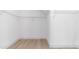 Empty walk-in closet featuring wood floors and metal shelving at 22706 N 17Th St, Phoenix, AZ 85024