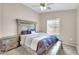 Bedroom with a queen bed with a wooden headboard and ceiling fan with light at 2727 N Price Rd # 6, Chandler, AZ 85224