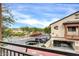 View of the home's exterior from the balcony with landscaping and car parking at 2727 N Price Rd # 6, Chandler, AZ 85224
