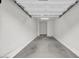 Spacious empty garage with white walls and smooth concrete flooring at 2727 N Price Rd # 6, Chandler, AZ 85224