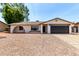 Charming single-story home with a two-car garage and low-maintenance desert landscaping at 3021 W Angela Dr, Phoenix, AZ 85053