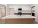 Modern kitchen featuring an island with seating and stylish lighting at 3021 W Angela Dr, Phoenix, AZ 85053