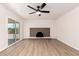 Empty living room featuring a fireplace, sliding glass door, and hardwood floors at 3021 W Angela Dr, Phoenix, AZ 85053
