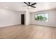 Open living room with hardwood floors, a ceiling fan, and a window for natural light at 3021 W Angela Dr, Phoenix, AZ 85053