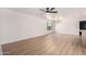 Spacious living room featuring updated flooring, a window for natural light, and contemporary ceiling fixture at 3021 W Angela Dr, Phoenix, AZ 85053