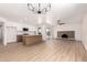 Open-concept living space features a modern kitchen with stainless steel appliances and a cozy fireplace at 3021 W Angela Dr, Phoenix, AZ 85053