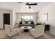Bright living room featuring a large window, ceiling fan, and neutral decor at 3021 W Angela Dr, Phoenix, AZ 85053