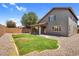 Spacious backyard with green grass and gravel landscaping and covered patio provides a serene outdoor space at 3376 E Lafayette Ave, Gilbert, AZ 85298