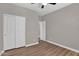 Bright bedroom features wood-look floors, closet, ceiling fan, and neutral paint at 3376 E Lafayette Ave, Gilbert, AZ 85298