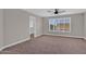 Bright bedroom features neutral carpet, ceiling fan, and shuttered window providing ample natural light at 3376 E Lafayette Ave, Gilbert, AZ 85298