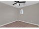 Bedroom with neutral walls and carpet features a ceiling fan and bright natural lighting at 3376 E Lafayette Ave, Gilbert, AZ 85298