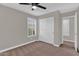 Bedroom with carpet features a closet with white doors and bright natural lighting at 3376 E Lafayette Ave, Gilbert, AZ 85298