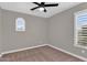 This bedroom features neutral walls, carpet, ceiling fan and bright natural lighting at 3376 E Lafayette Ave, Gilbert, AZ 85298