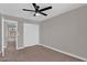 This bedroom has neutral carpet, a ceiling fan, closet, and a view to the hallway at 3376 E Lafayette Ave, Gilbert, AZ 85298