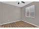 Empty bedroom featuring wood-look floors, a ceiling fan, and natural light at 3376 E Lafayette Ave, Gilbert, AZ 85298