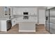 Bright kitchen features white cabinetry, stainless steel appliances, and a center island with quartz countertops at 3376 E Lafayette Ave, Gilbert, AZ 85298
