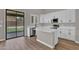 Bright kitchen features white cabinetry, stainless steel appliances, and a center island with quartz countertops at 3376 E Lafayette Ave, Gilbert, AZ 85298