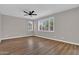 Spacious living room features wood floors, a ceiling fan, and plantation shutters for bright, natural light at 3376 E Lafayette Ave, Gilbert, AZ 85298