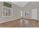 Living room has a vaulted ceiling, wood look floors and large windows with plantation shutters at 3376 E Lafayette Ave, Gilbert, AZ 85298