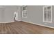 Living room has a vaulted ceiling, wood look floors and large windows with plantation shutters at 3376 E Lafayette Ave, Gilbert, AZ 85298