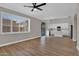 Bright living space with wood-look floors, fan, plus an open layout connected to the modern kitchen at 3376 E Lafayette Ave, Gilbert, AZ 85298