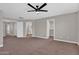 Large main bedroom boasts neutral carpet, ceiling fan, and a view to bathroom and walk-in closet at 3376 E Lafayette Ave, Gilbert, AZ 85298