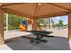 Shaded picnic table offers a place to relax near the community playground and climbing area at 3376 E Lafayette Ave, Gilbert, AZ 85298
