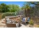 Inviting backyard featuring a hot tub, comfortable seating around a fire pit, and lush landscaping at 3766 E Ringtail Way, Phoenix, AZ 85050