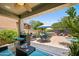 Spacious backyard with covered patio, outdoor kitchen, and a pool area with comfortable seating at 3766 E Ringtail Way, Phoenix, AZ 85050