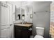 Bathroom features a granite topped vanity with a sink, with artwork and toilet nearby at 3766 E Ringtail Way, Phoenix, AZ 85050