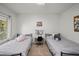Well lit bedroom with two beds, ceiling fan, and large window view at 3766 E Ringtail Way, Phoenix, AZ 85050